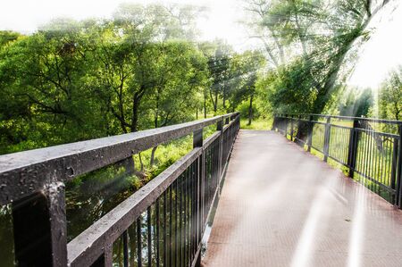 passage into the park through the old bridgeの写真素材