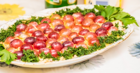 easy festive salad garnished sliced grapes and herbsの写真素材