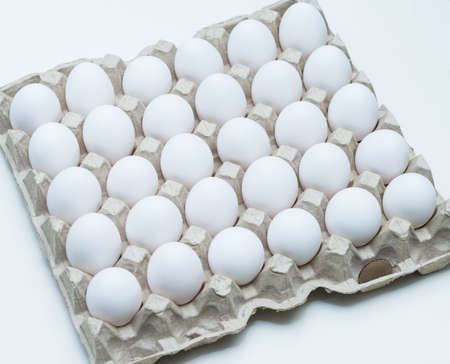 chicken egg white neatly stacked in a cellの写真素材