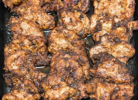 fried pieces of meat in the panの写真素材
