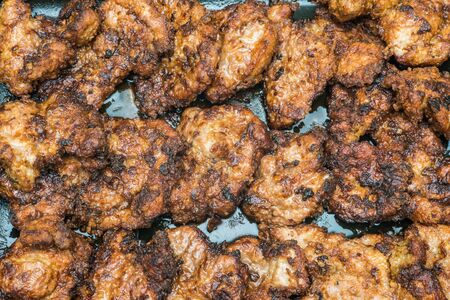 fried pieces of meat in the panの写真素材