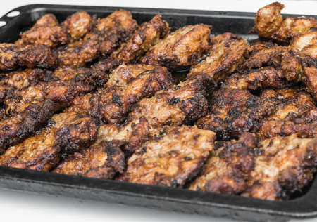 fried pieces of meat in the panの写真素材