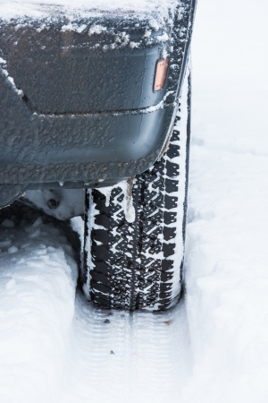 wheel of a car stuck in the snowの写真素材