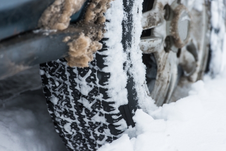 wheel of a car stuck in the snowの写真素材