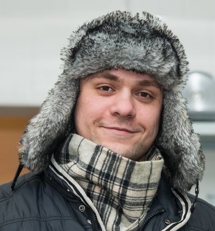 young man in winter fur hat with ear flapsの写真素材