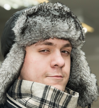 young man in winter fur hat with ear flapsの写真素材