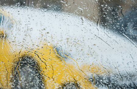 rain drops on glass with a backgroundの写真素材