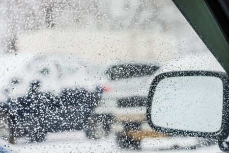 rain drops on glass with a backgroundの写真素材