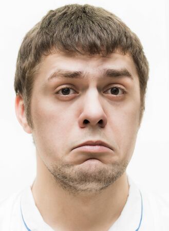 A young man makes a face to faceの写真素材