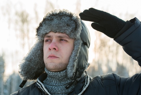 a man in a fur winter hat with ear flapsの写真素材