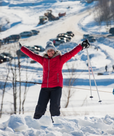 middle-aged woman alpine skiing in the snow in winterの写真素材