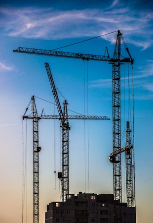 Lift crane building a new residential buildingの写真素材