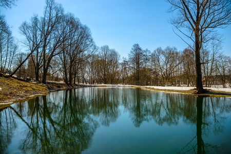 clear pond in the park with orazheniem sky in early springの写真素材
