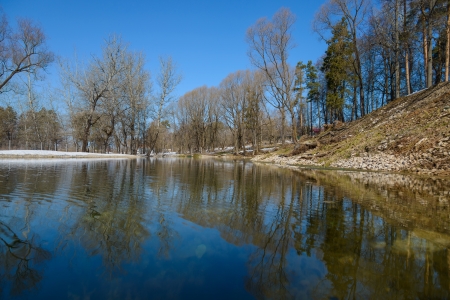 clear pond in the park with orazheniem sky in early springの写真素材