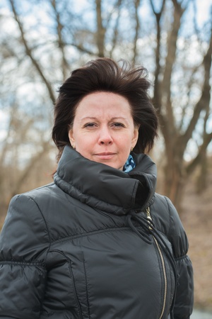 portrait of a middle-aged brunette in a black jacket fallの写真素材
