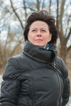 portrait of a middle-aged brunette in a black jacket fallの写真素材
