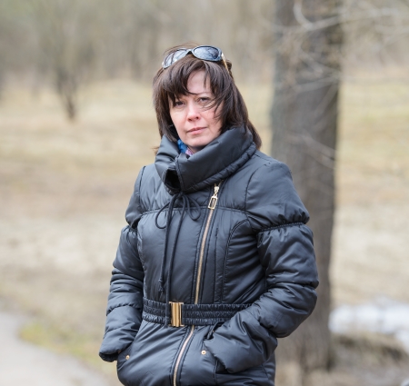 portrait of a middle-aged brunette in a black jacket fallの写真素材