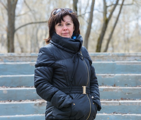 portrait of a middle-aged brunette in a black jacket fallの写真素材