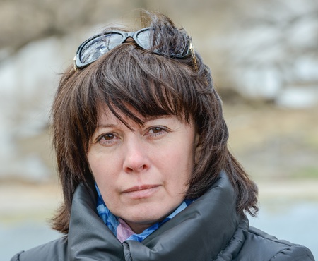portrait of a middle-aged brunette in a black jacket fallの写真素材