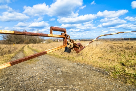 barrier in a field on the lock with a chainの写真素材