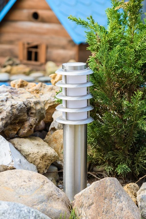 small lantern in a garden on the groundの写真素材