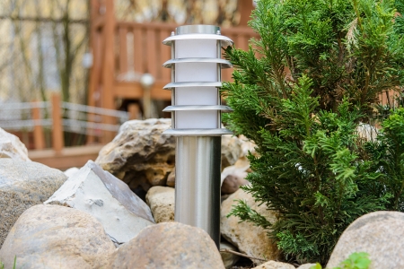small lantern in a garden on the groundの写真素材