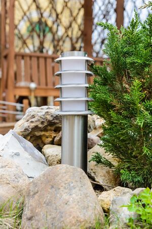 small lantern in a garden on the groundの写真素材