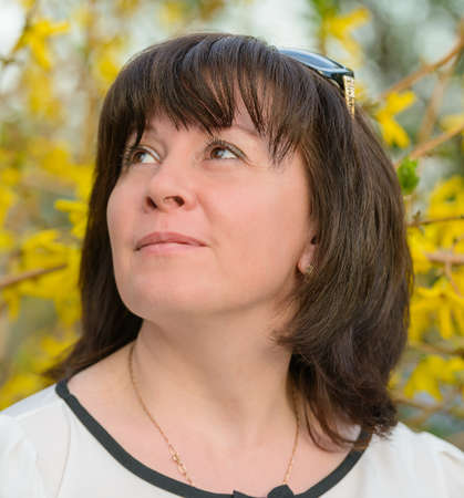 portrait of a middle-aged brunette woman on a background of natureの写真素材