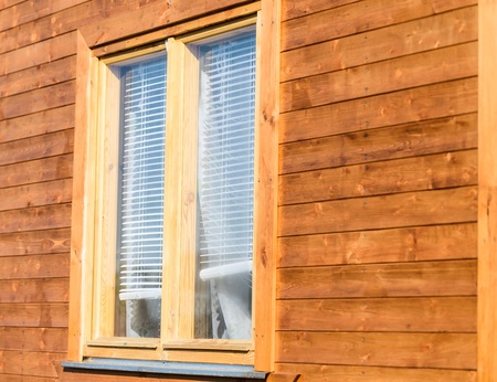 wall of a village house with wooden window and shutterの写真素材