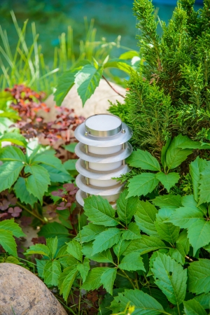 small lantern in a garden on the groundの写真素材