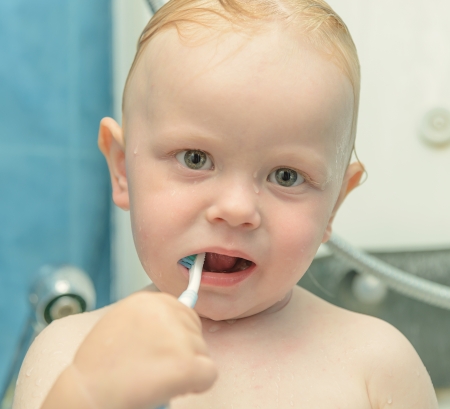 little boy in the shower brushing and toothpasteの写真素材