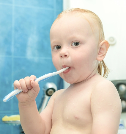 little boy in the shower brushing and toothpasteの写真素材