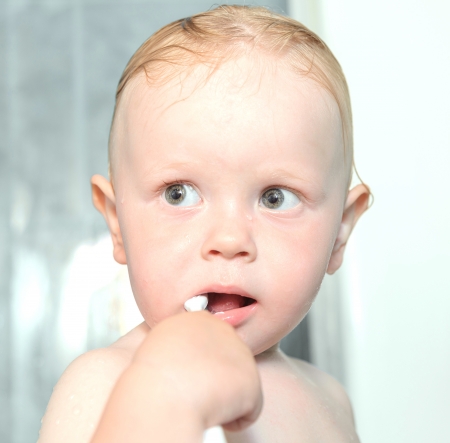 little boy in the shower brushing and toothpasteの写真素材