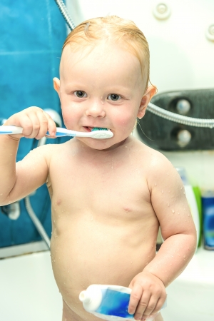 little boy in the shower brushing and toothpasteの写真素材
