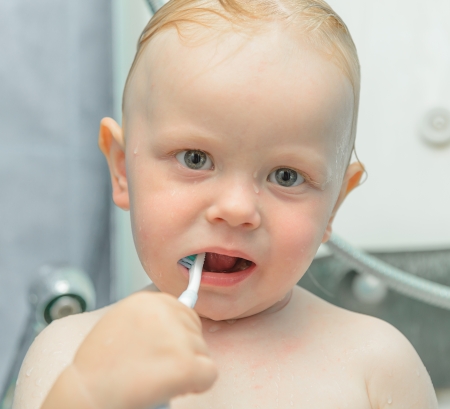 little boy in the shower brushing and toothpasteの写真素材