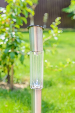 small lantern in a garden on the groundの写真素材