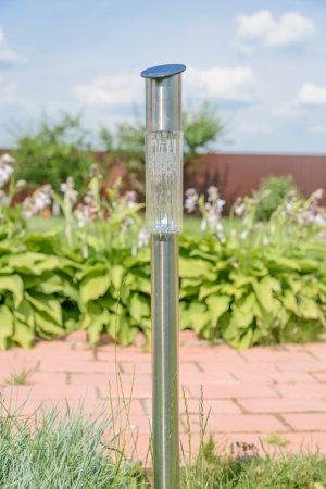small lantern in a garden on the groundの写真素材