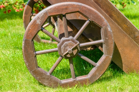 old brown wooden cart on the green lawn in the gardenの写真素材