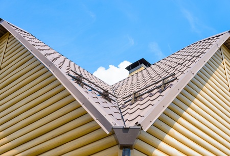 chimney on the roof of the house against the blue skyの写真素材