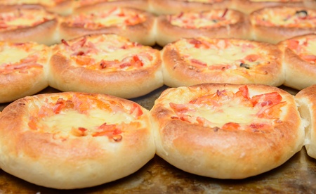 Finished on a baking hot mini pizza with cheeseの写真素材