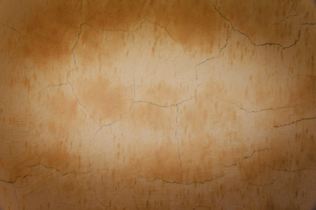 brown wall with cracked plaster timeの写真素材
