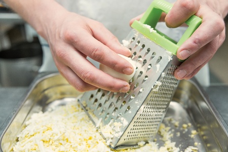 cook eggs rubs on the metal graterの写真素材