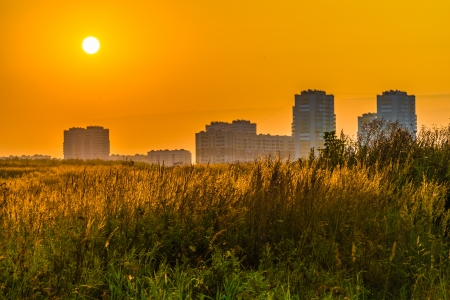 city on the background of the rising sun orangeの写真素材
