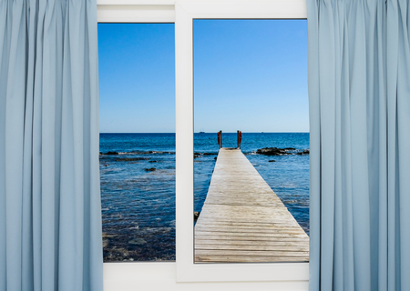 the view from the open window on the sea with a quayの写真素材