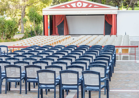 facing a number of seats for the audience in the concert hall in the open air