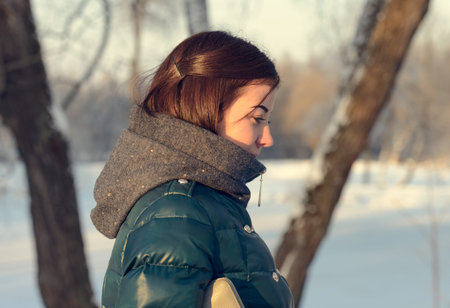 Young brunette woman in a winter jacket portrait
