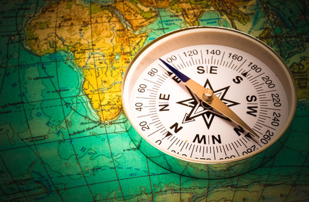 The compass lies on the modern world mapの写真素材