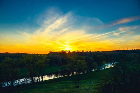 Decline in clouds of the sun with beams backgroundの写真素材