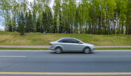 car in motion blur out of focus at great speedの写真素材