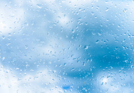 rain drops on glass with a backgroundの写真素材